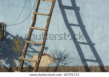 old wooden stair against the wall of a rural house