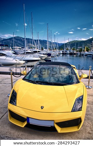 PORTO MONTENEGRO, TIVAT, MONTENEGRO - YULY 18: yellow Lamborghini Gallardo parking in reserved area superyacht marina of Porto Montenegro. Shot in 2014