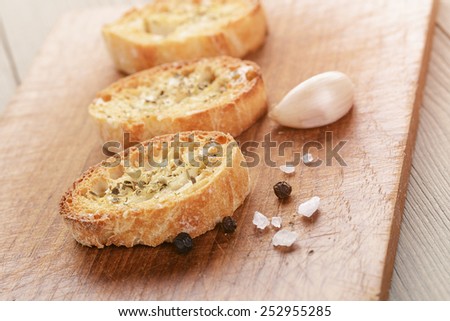 crostini with olive oil and garlic, on cutting board