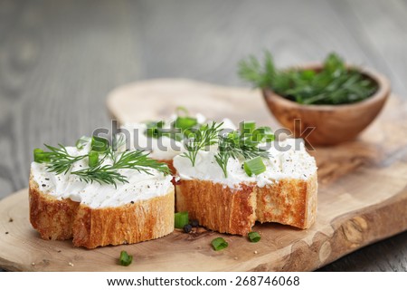 homemade appetizing crostini with soft cheese cream herbs