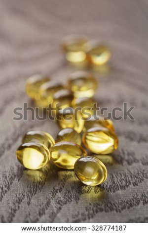 fish oil capsules on wooden tabe health supplement