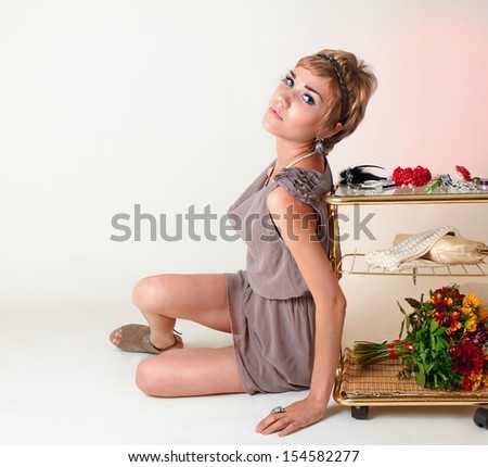 Young pretty girl siting near the dress table
