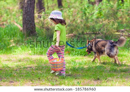 Little girl going to picnic with dog