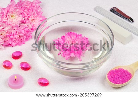 Place for manicure, bowl of water with rose chrysanthemum flower