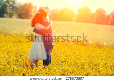 Just married couple hugging in the meadow