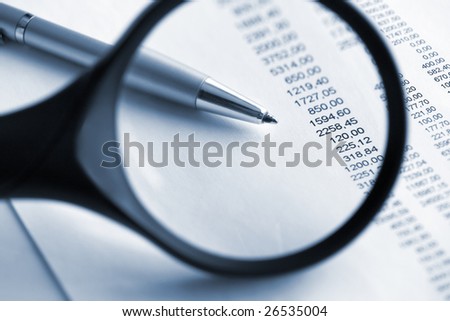 Financial  analyze with magnifying glass. Close up