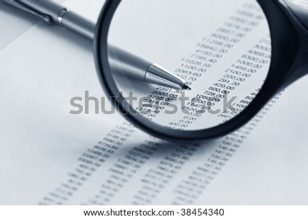 Magnifying glass over financial report