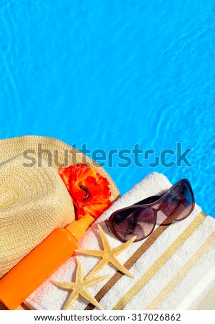 Beach hat, sunglasses, bath towel, sun spray, starfish near the swimming pool