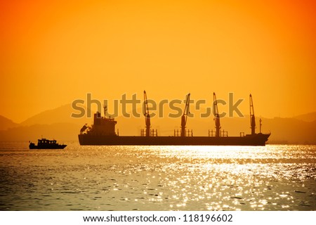 Silhouette of the sea ship on a sunset