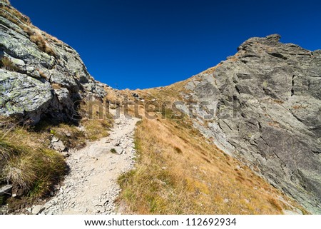 Landscape with mountain trail and clear blue sky