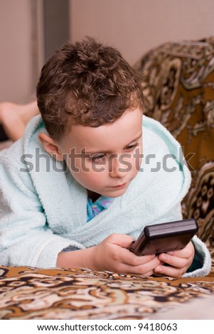 Beautiful boy playing at an electronic game