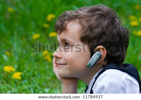 Seven years old businessman with mobile technology
