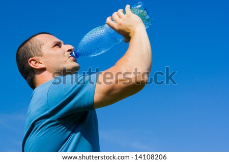 Portrait of a young man drinking water