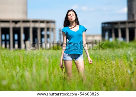 Portrait of a beautiful young woman in an industrial background