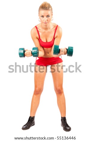 Young woman in red shorts and top doing workout with weights, isolated on white