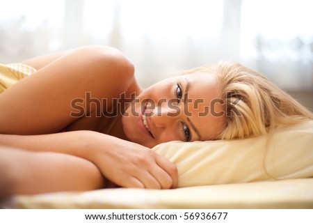 Close up portrait of a beautiful blonde woman preparing to sleep (or just awaken in the morning)