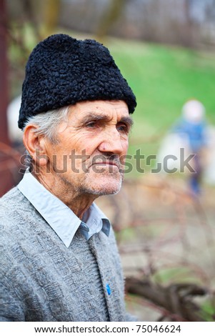 Closeup portrait of a senior farmer with woolly hat outdoor