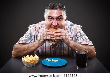 stock-photo-portrait-of-a-greedy-fat-man-eating-burger-on-gray-background-114954811.jpg