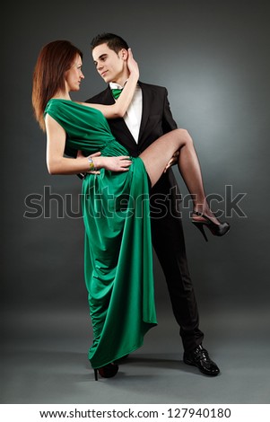 Elegant and passionate romantic couple dancing tango in full length pose