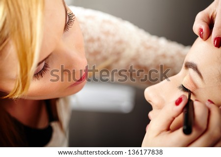 Closeup of a makeup artist applying makeup