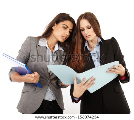 Two successful businesswomen discussing and looking to documents isolated on white
