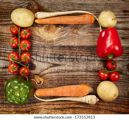 Closeup of a vegetables frame on a rustic wooden board with copyspace