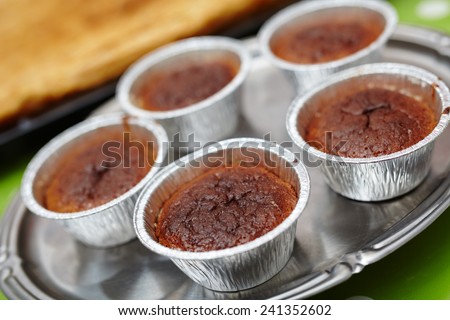 Chocolate lava cake in baking cups on a tray, closeup