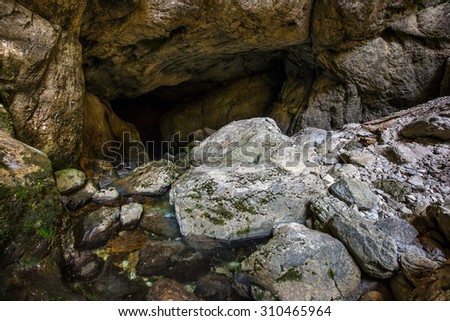 Entrance of a cave with underground river in Apuseni mountains, Romania