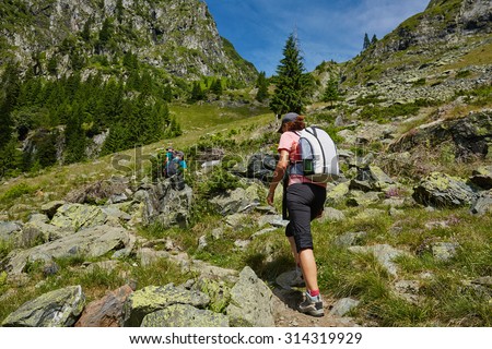 Group of hikers on a trail in the mountains in a beautiful scenery