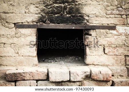 Smoky antique brick oven outdoor with ashes inside