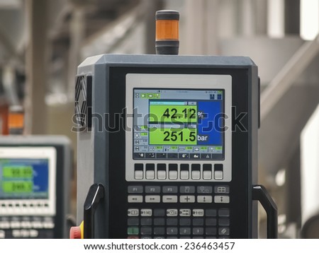 Heavy machines and digital displays in production line. Closeup digital display control panel.