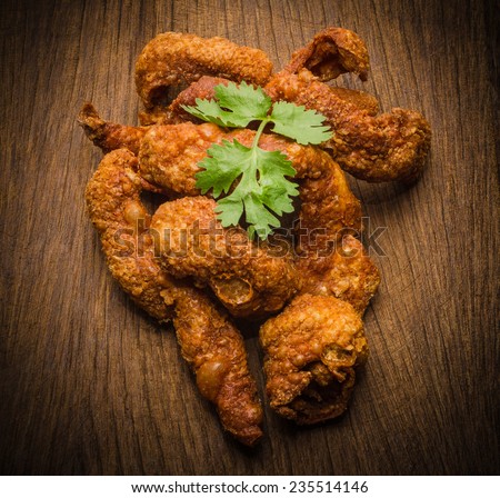 fried healthy chicken cooked on a summer fresh herbs on a wooden board, close up view