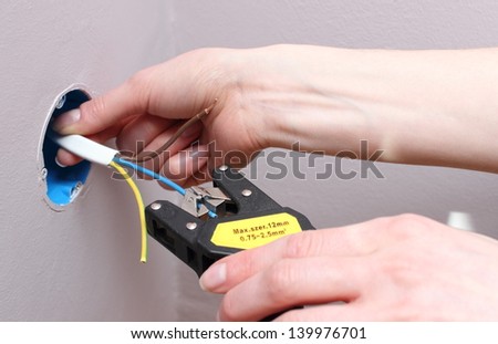 Electrician insulating electric wires of an electric box