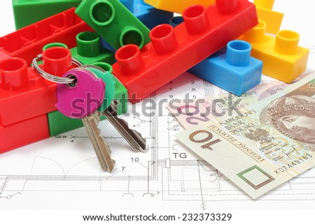 Closeup of home keys, heap of colorful building blocks and banknote lying on construction drawing of house, building blocks for children, housing plan with building blocks, finance concept