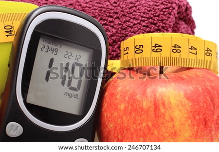 Glucometer, fresh apple and tape measure, concept for diabetes, lifestyle and healthy nutrition