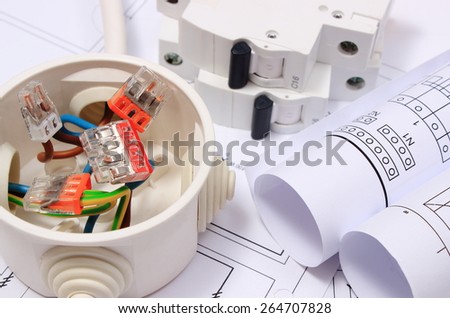 Copper wire connections in electrical box, rolls of electrical diagrams and electric fuse on construction drawing of house, accessories for engineering work, energy concept