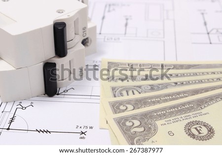 Electric fuse and money on electrical construction drawing of house, accessories for engineering work, concept for energy saving