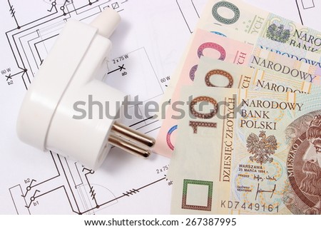 Electric plug and money on electrical construction drawing of house, accessories for engineering work, concept for energy saving