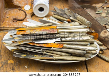 Heap of antique old rusty knives for sale on stall at the bazaar