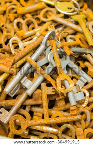 Heap of antique old rusty keys for sale on stall at the bazaar as background