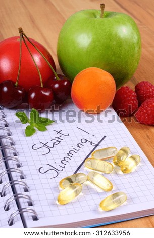 Fresh fruits, vegetables and tablets supplements with notebook for writing notes, choice between healthy eating and slimming pills