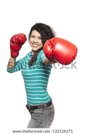Young woman wearing boxing gloves smiling on white background