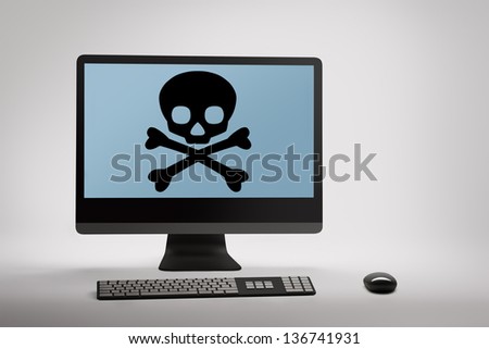 Desktop computer displaying conceptual internet fraud and scam warning on screen