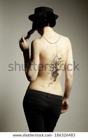 Body art temporary tattoo on female back isolated on white background