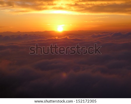 Sunrise/ red clouds on the mountain top View from the mountain peak/ a new day