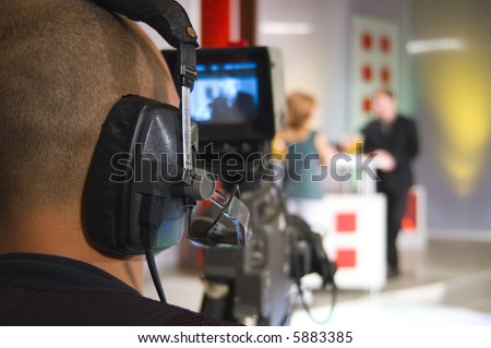 Cameraman works in the studio - recording show in TV studio