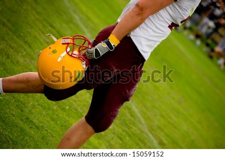 American football helmet in the hand