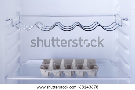 The inside of a refrigerator with empty card tray