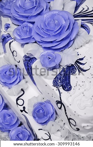 Big white wedding cake decorated with flowers