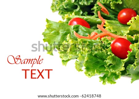 Fresh green lettuce salad with shredded carrots and grape tomatoes on white background with copy space.  Macro with shallow dof.